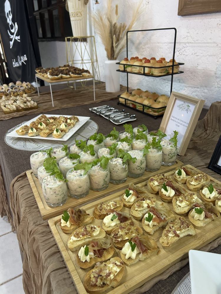 Mesa de coffee break con bandejas de bocados